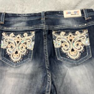 Grace in LA ladies jeans. Has clear rhinestones, sequins & colored thread.
